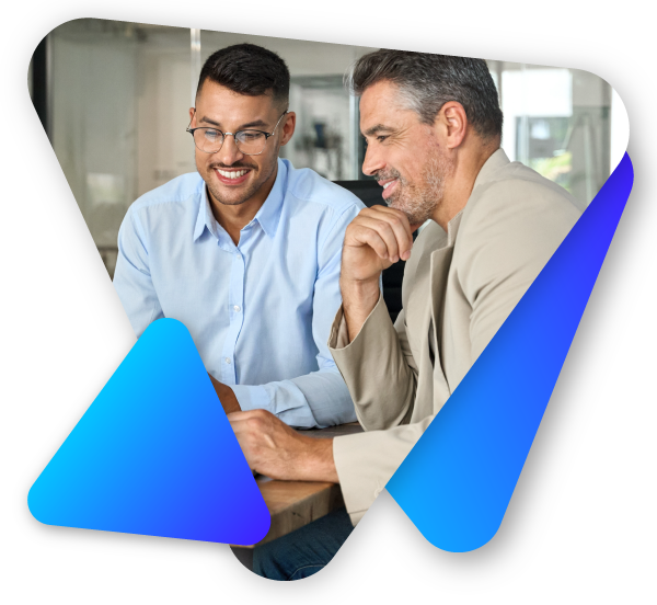 Two men smiling and looking at a laptop screen in a bright office setting.