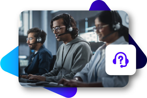 Three people with headsets working at computers in a control room or server environment.